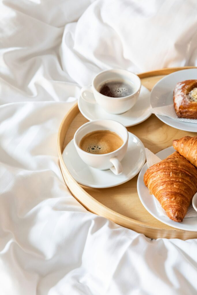 A breakfast tray with coffee and croissants